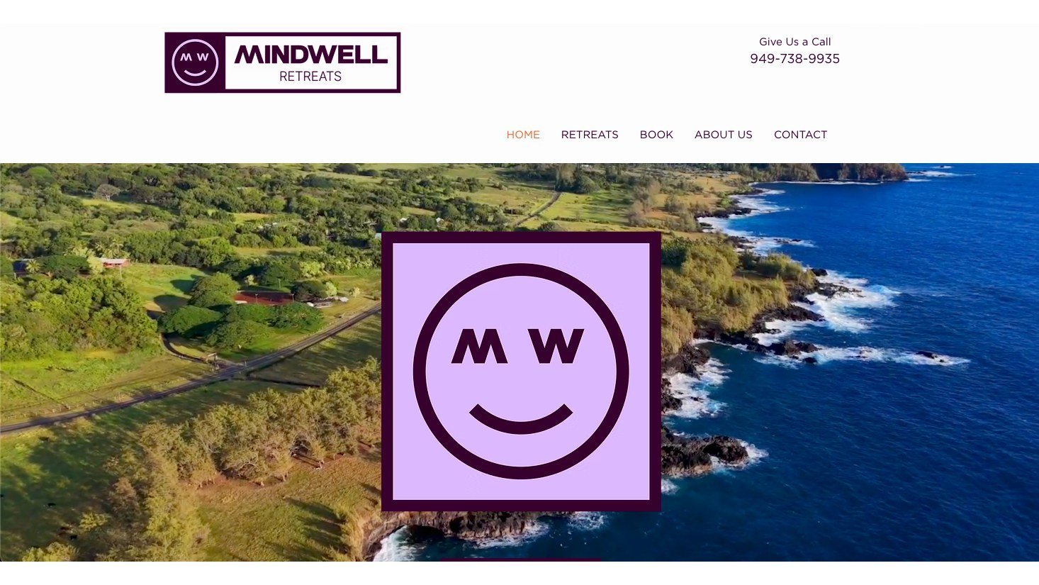 The MindWell Retreats homepage, the smile mark over an aerial of the Hana coastline