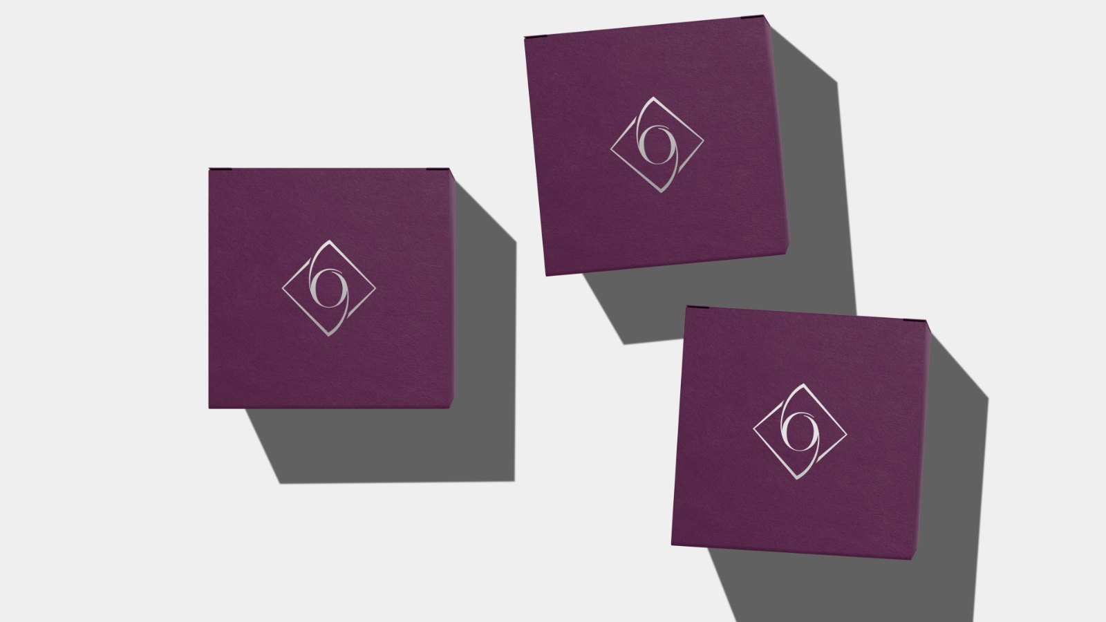 Plum packaging boxes carrying the Opulen monogram.