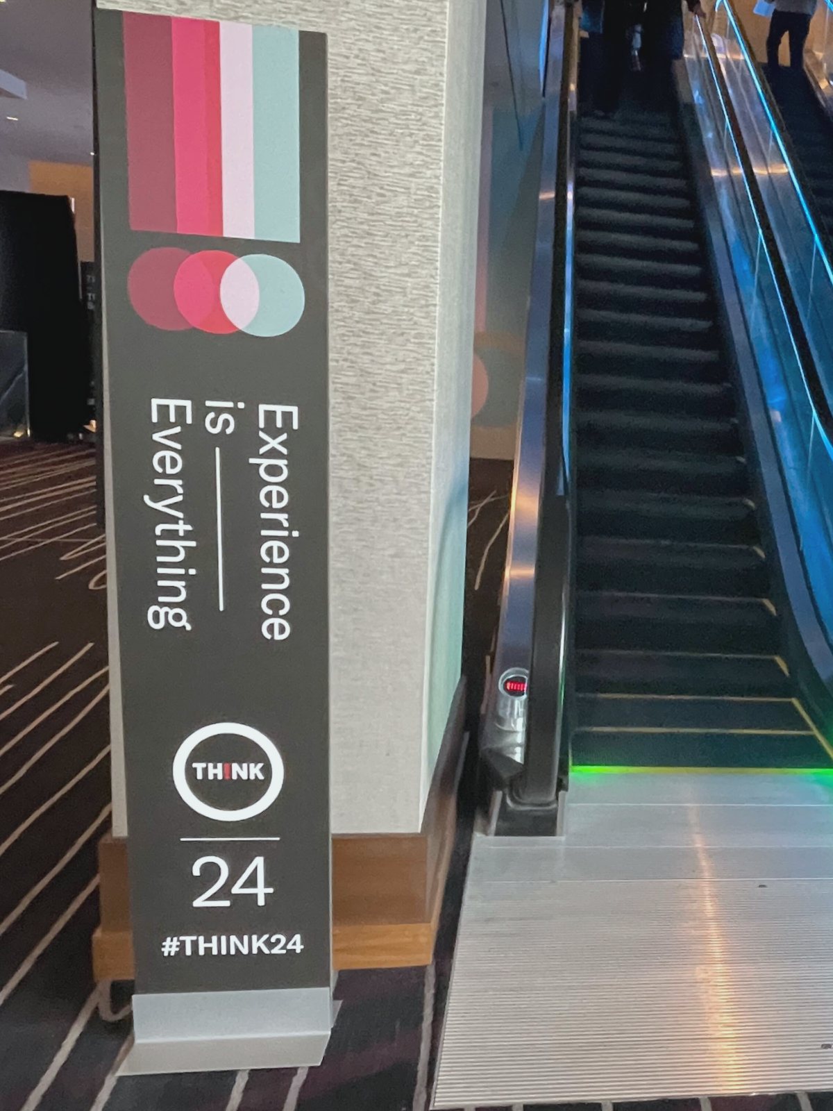 An Experience is Everything wayfinding tower at the foot of the escalator to the second floor.